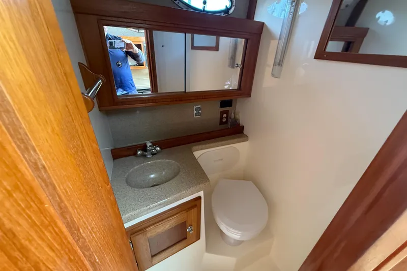 Slide: The Image of 2005 Albemarle 280 Express Fisherman boat bathroom with sink, mirror, and toilet. - 48
