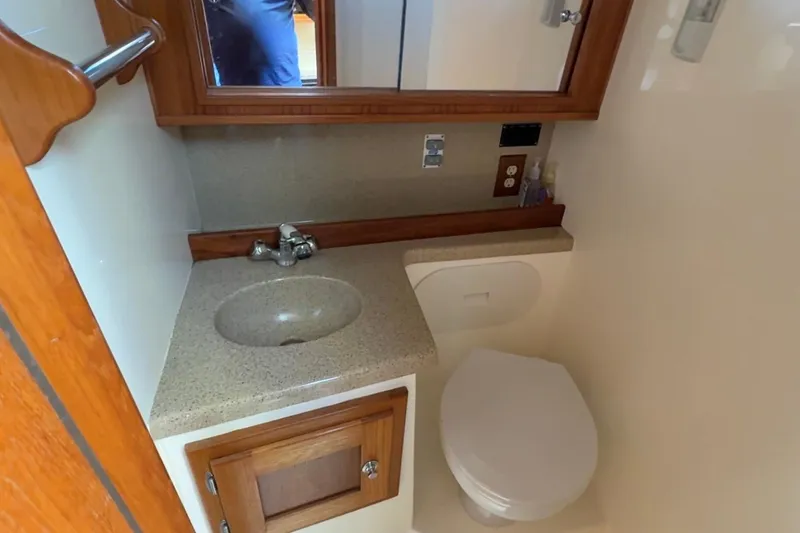 Slide: The Image of Compact bathroom in 2005 Albemarle 280 Express Fisherman boat with sink and toilet. - 49
