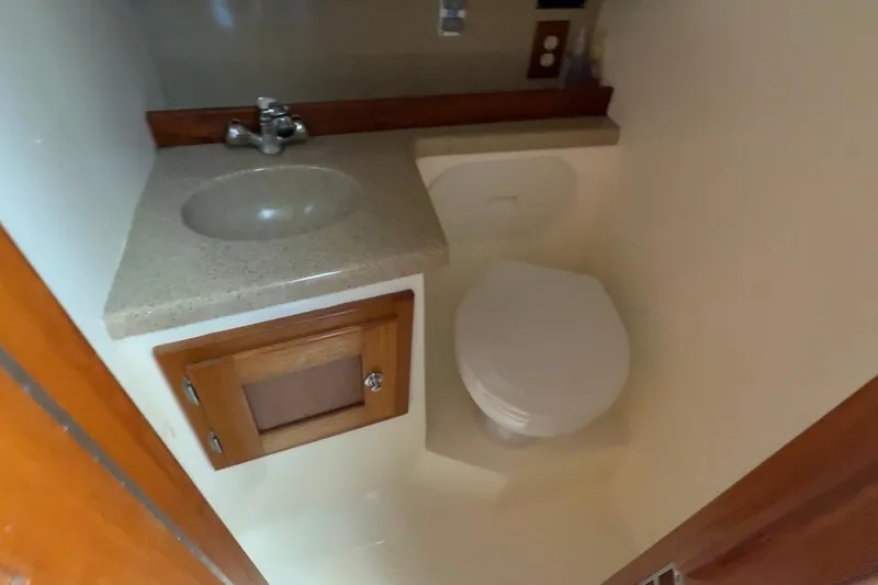 Slide: The Image of Compact bathroom in 2005 Albemarle 280 Express Fisherman boat with sink and toilet. - 50