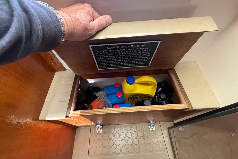 Slide: The Image of Storage compartment on a 2005 Albemarle 280 Express Fisherman with various maintenance supplies. - 51