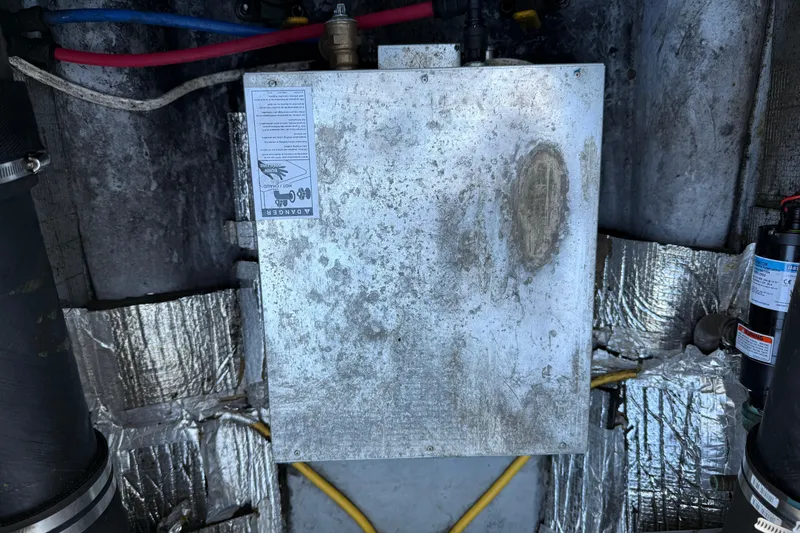 Slide: The Image of Engine compartment of 2005 Albemarle 280 Express Fisherman with metal panel and wiring. - 58