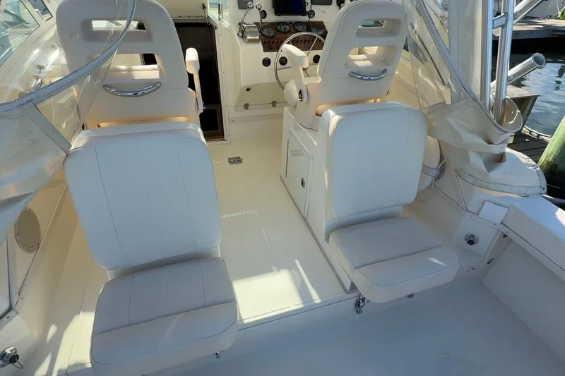 Slide: The Image of 2005 Albemarle 280 Express Fisherman boat interior with white seating and helm station. - 7