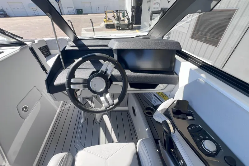 Slide: The Image of 2025 Nautique Super Air Nautique G21 cockpit with modern steering and controls. - 12