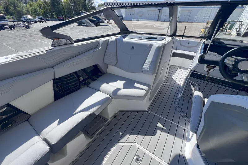 Slide: The Image of 2025 Nautique Super Air Nautique G21 interior with sleek seating and modern design. - 14