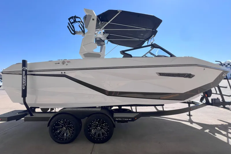 Slide: The Image of 2025 Nautique Super Air Nautique G21 boat on trailer, side view, sunny day. - 6