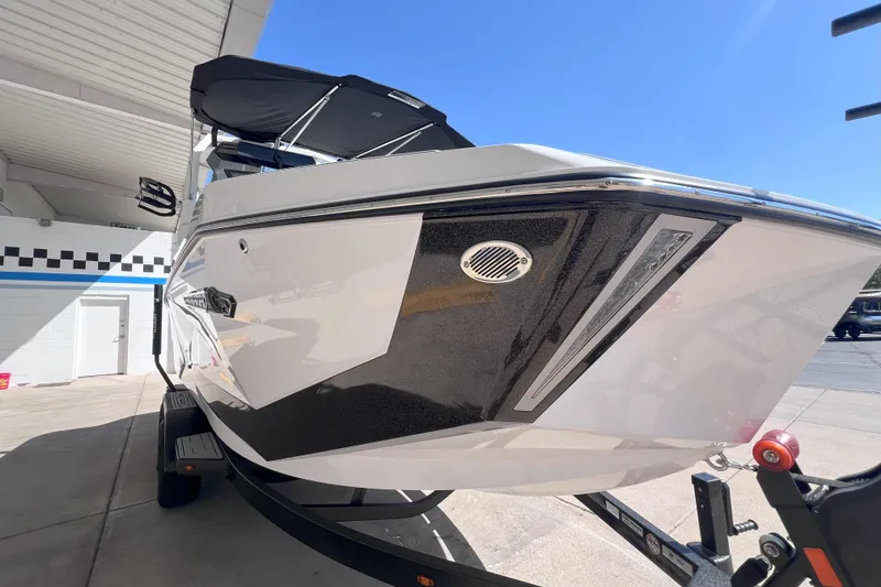 Slide: The Image of 2025 Nautique Super Air Nautique G21 boat on trailer, under sunny sky. - 7