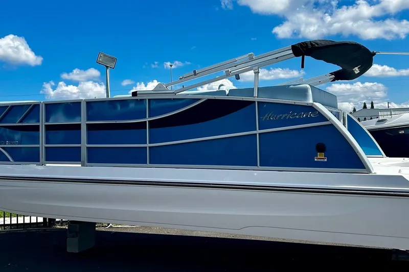 Slide: The Image of 2025 Hurricane FunDeck 2260 RE OB boat under a clear blue sky. - 1