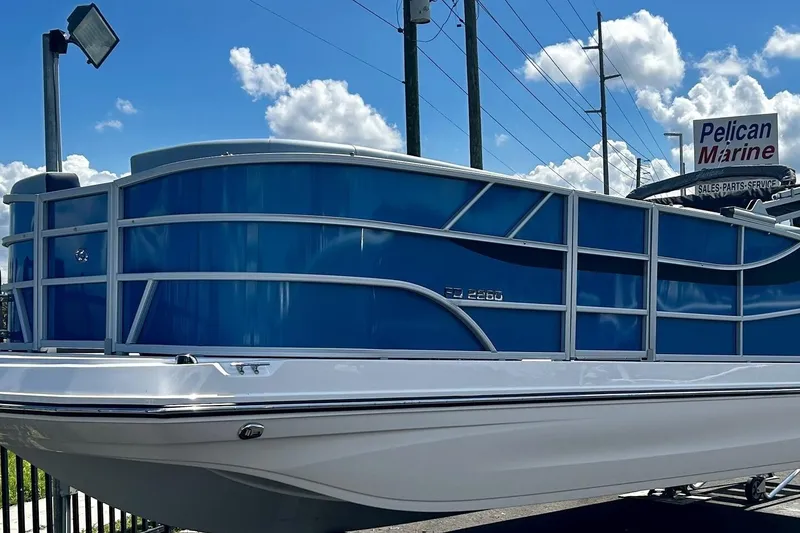 Slide: The Image of 2025 Hurricane FunDeck 2260 RE OB boat displayed at Pelican Marine dealership. - 2