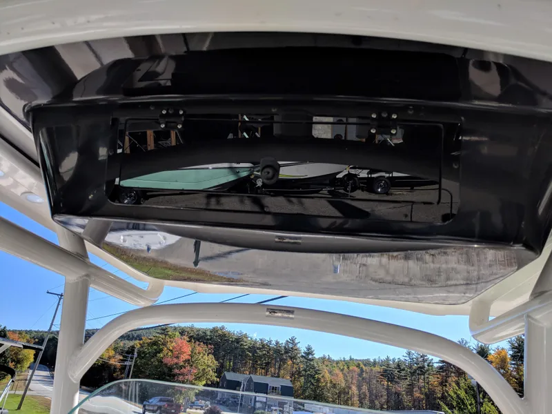 Slide: The Image of 2018 Wellcraft 242 Fisherman boat console with electronics, under a clear blue sky. - 10