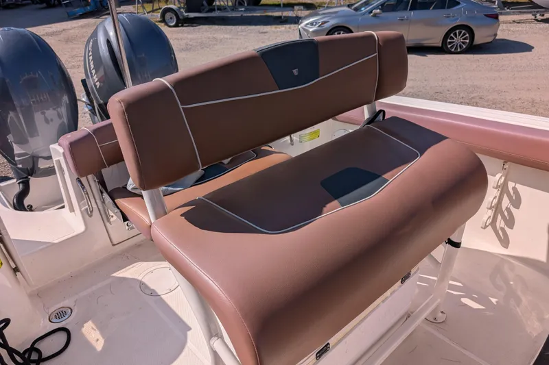 Slide: The Image of 2018 Wellcraft 242 Fisherman boat with brown seating and dual Yamaha engines. - 11