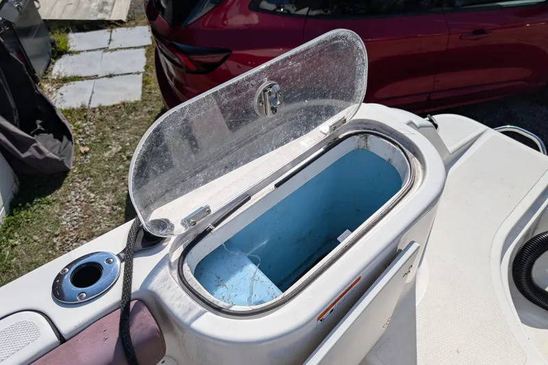 Slide: The Image of Open storage compartment on 2018 Wellcraft 242 Fisherman boat, with clear lid and blue interior. - 15
