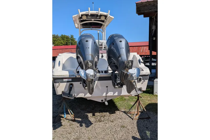 Slide: The Image of 2018 Wellcraft 242 Fisherman boat with dual outboard engines on stands. - 16