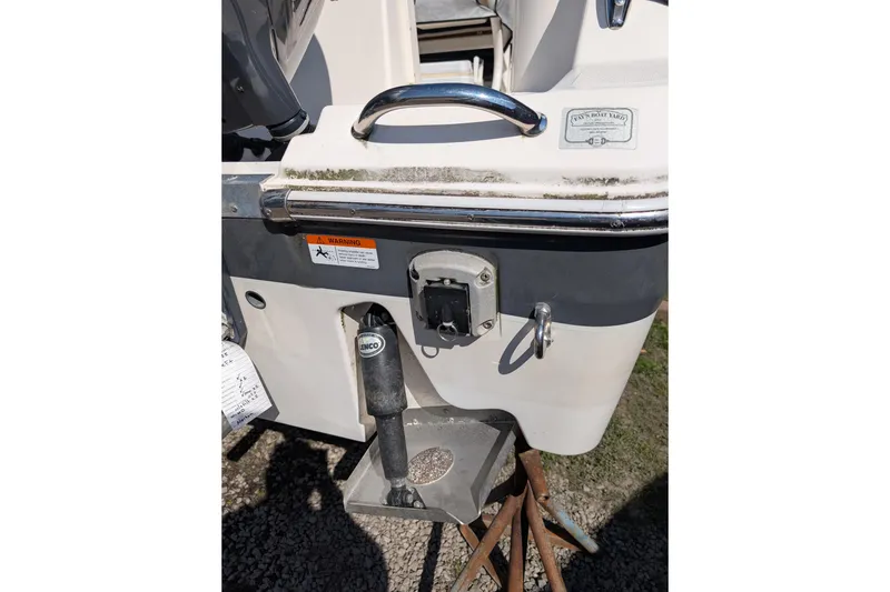 Slide: The Image of 2018 Wellcraft 242 Fisherman boat stern with trim tab and warning label. - 17