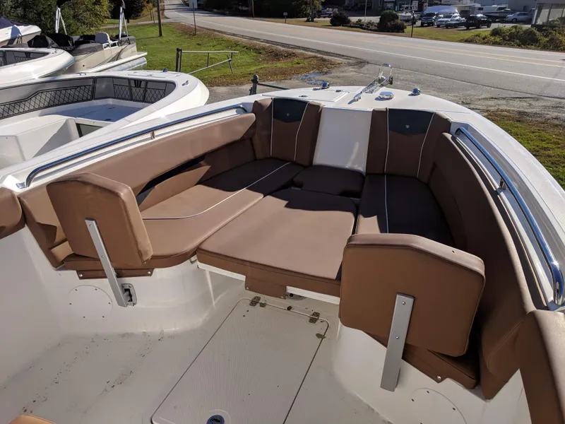 Slide: The Image of 2018 Wellcraft 242 Fisherman boat with brown cushioned seating in the bow area. - 2