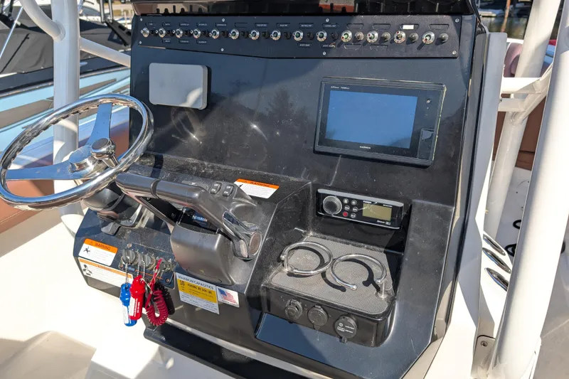 Slide: The Image of Control panel of a 2018 Wellcraft 242 Fisherman boat with steering wheel and electronics. - 6