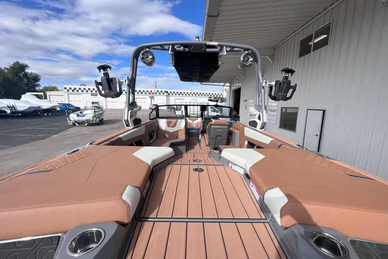 Slide: The Image of 2024 Nautique Super Air Nautique GS22 boat interior with tan seating and modern design. - 10