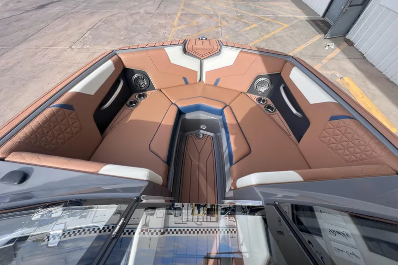 Slide: The Image of 2024 Nautique Super Air Nautique GS22 boat interior with brown and white seating. - 14