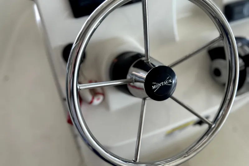 Slide: The Image of Steering wheel of a 2020 Boston Whaler 170 Montauk boat, close-up view. - 13