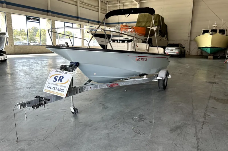 Slide: The Image of 2020 Boston Whaler 170 Montauk boat on trailer in indoor showroom. - 3