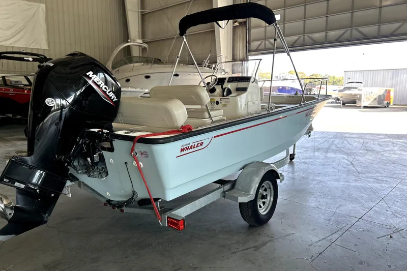 Slide: The Image of 2020 Boston Whaler 170 Montauk boat with Mercury engine in a storage facility. - 4