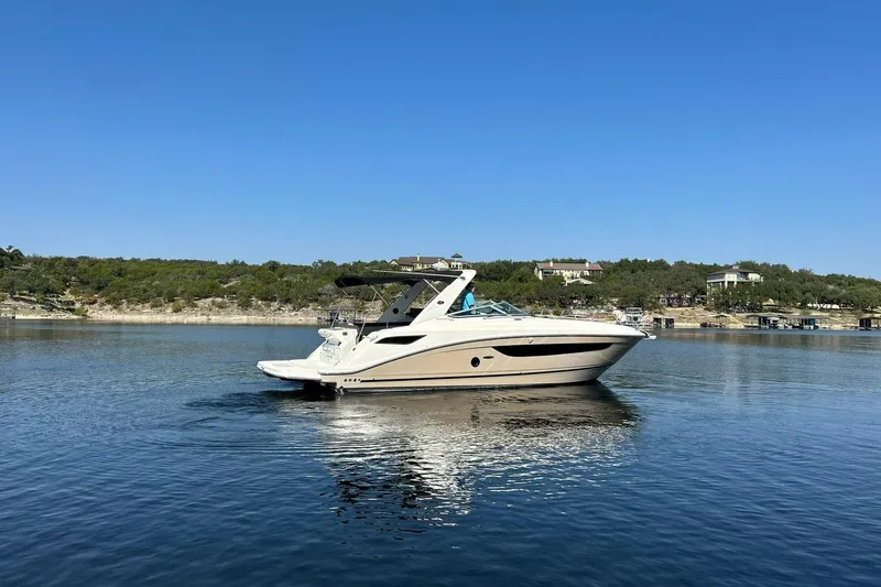 Slide: The Image of 2014 Sea Ray 350 Sundancer yacht on calm water, clear blue sky background. - 19