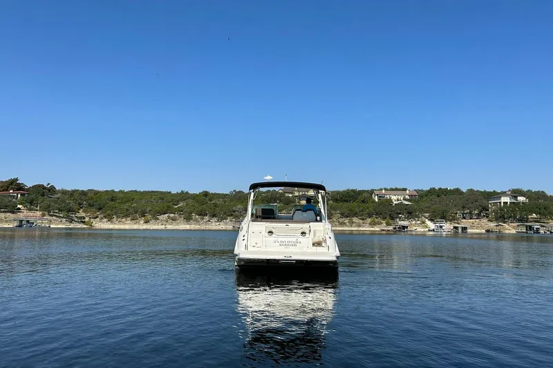 Slide: The Image of 2014 Sea Ray 350 Sundancer on calm lake under clear blue sky. - 22