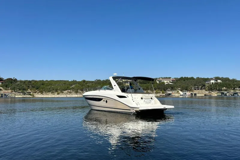 Slide: The Image of 2014 Sea Ray 350 Sundancer boat on calm lake with clear blue sky. - 24