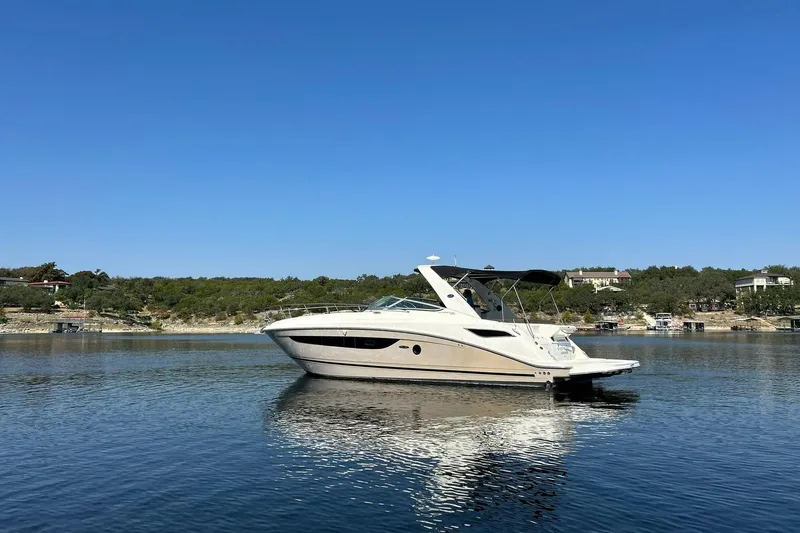 Slide: The Image of 2014 Sea Ray 350 Sundancer yacht on calm water under clear blue sky. - 25