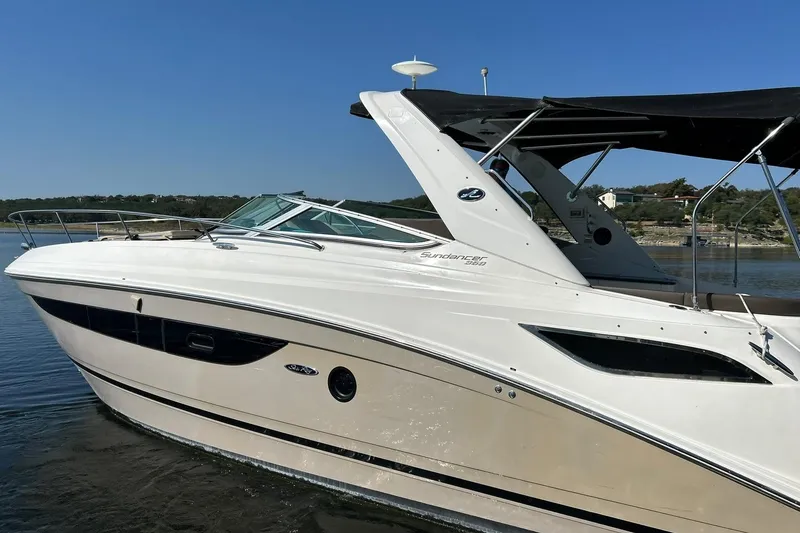 Slide: The Image of 2014 Sea Ray 350 Sundancer boat on calm water, side view. - 27