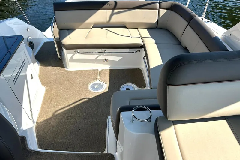 Slide: The Image of 2014 Sea Ray 350 Sundancer boat interior with beige seating and carpeted floor. - 3