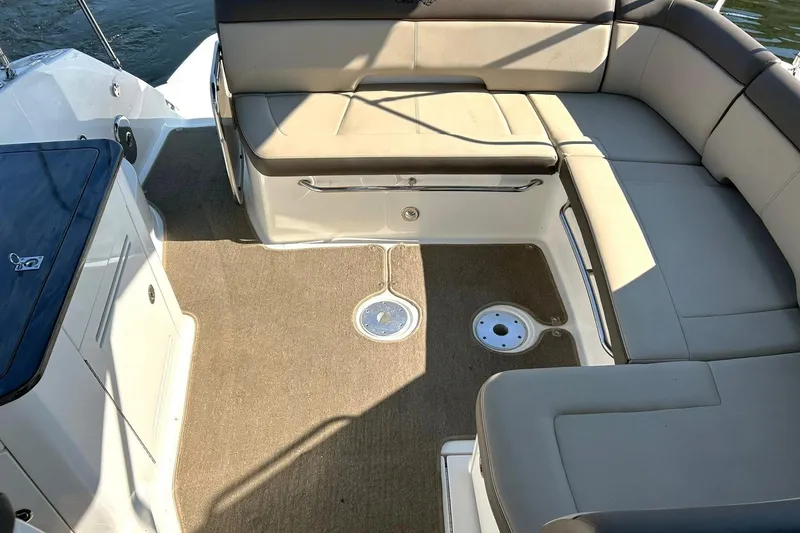 Slide: The Image of 2014 Sea Ray 350 Sundancer boat interior with beige seating and carpeted floor. - 30