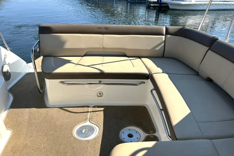Slide: The Image of 2014 Sea Ray 350 Sundancer boat interior with beige seating and water view. - 31