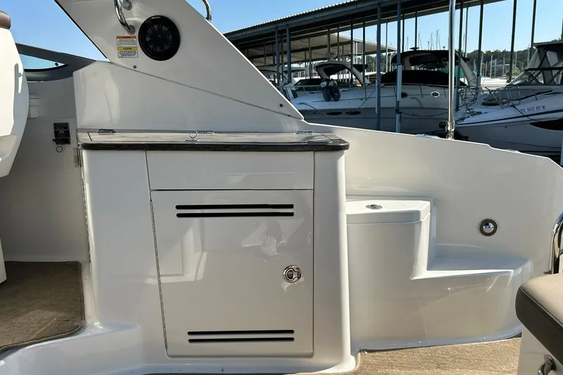 Slide: The Image of 2014 Sea Ray 350 Sundancer boat interior with storage cabinet and seating area. - 35