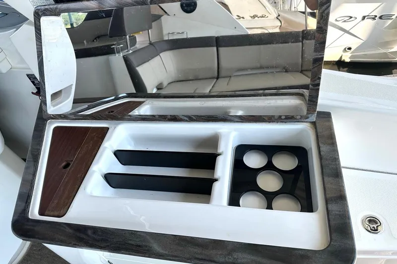 Slide: The Image of 2014 Sea Ray 350 Sundancer interior with cup holders and storage compartments. - 37