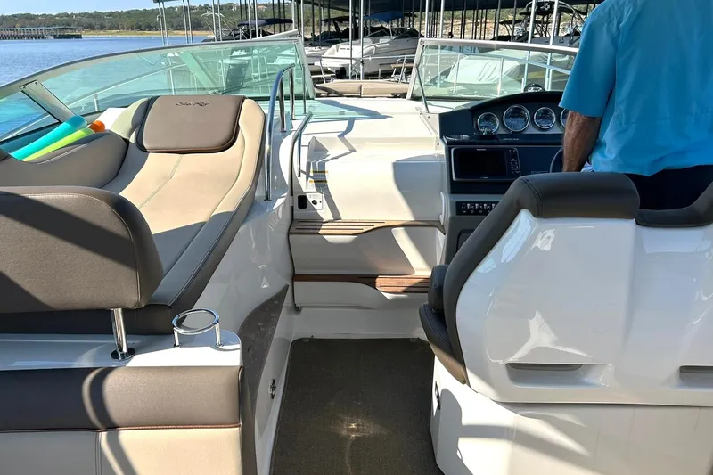 Slide: The Image of 2014 Sea Ray 350 Sundancer boat interior with seating and control panel. - 38