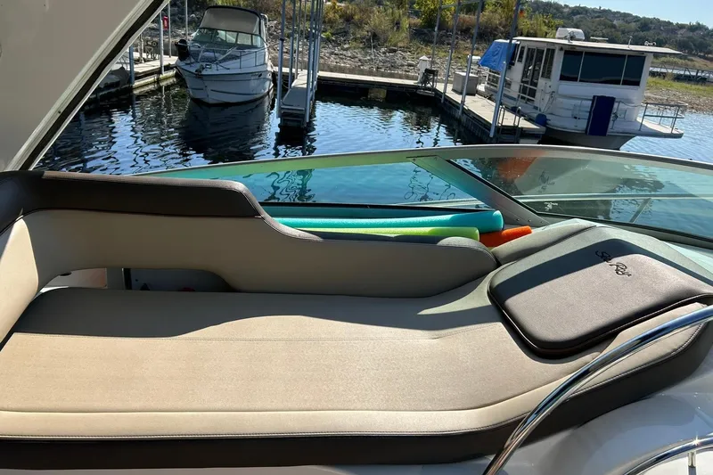 Slide: The Image of 2014 Sea Ray 350 Sundancer boat interior with sunbed and colorful pool noodles. - 39