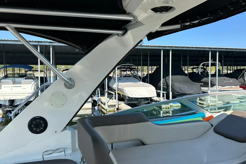 Slide: The Image of 2014 Sea Ray 350 Sundancer in marina, featuring sleek design and comfortable seating. - 40