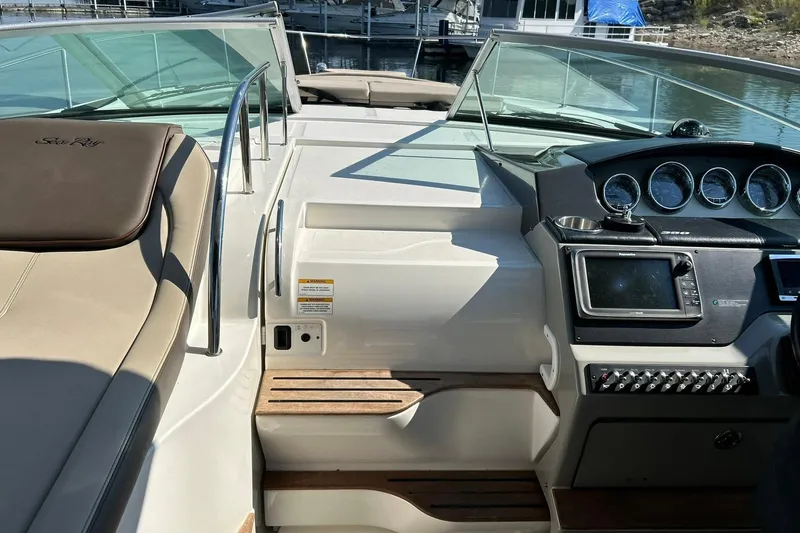 Slide: The Image of 2014 Sea Ray 350 Sundancer cockpit with navigation controls and seating area. - 41