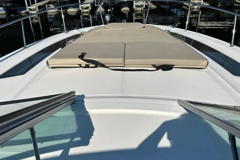 Slide: The Image of 2014 Sea Ray 350 Sundancer boat with sunpad on deck, docked at marina. - 42