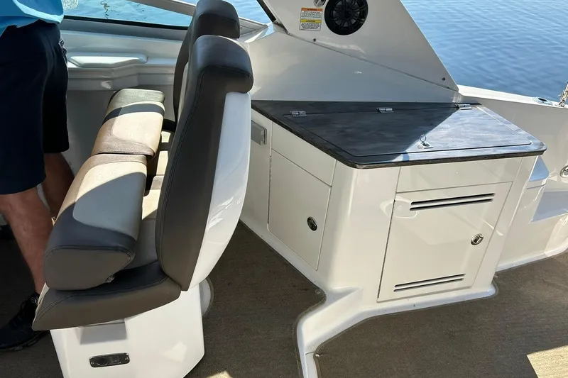 Slide: The Image of 2014 Sea Ray 350 Sundancer interior with seating and storage, featuring sleek design and functionality. - 45