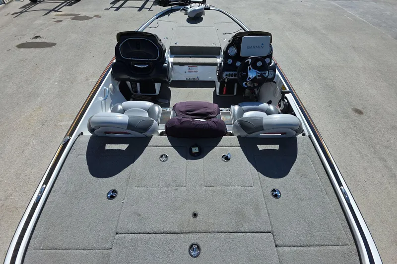 Slide: The Image of 2011 Nitro Z-8 boat interior with Garmin equipment, featuring spacious seating and carpeted deck. - 10