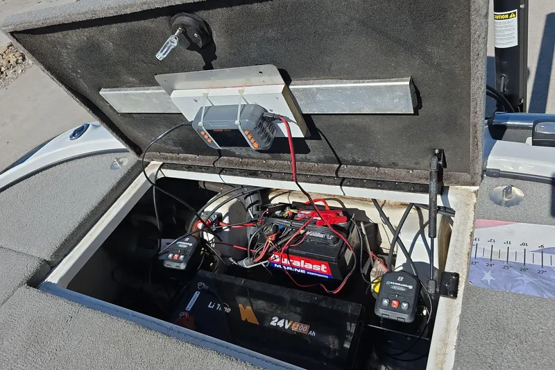 Slide: The Image of Open battery compartment of 2011 Nitro Z-8 boat with wiring and chargers visible. - 16