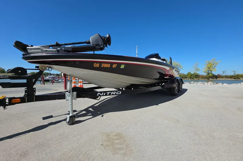 Slide: The Image of 2011 Nitro Z-8 boat on trailer, clear sky, waterfront background. - 2