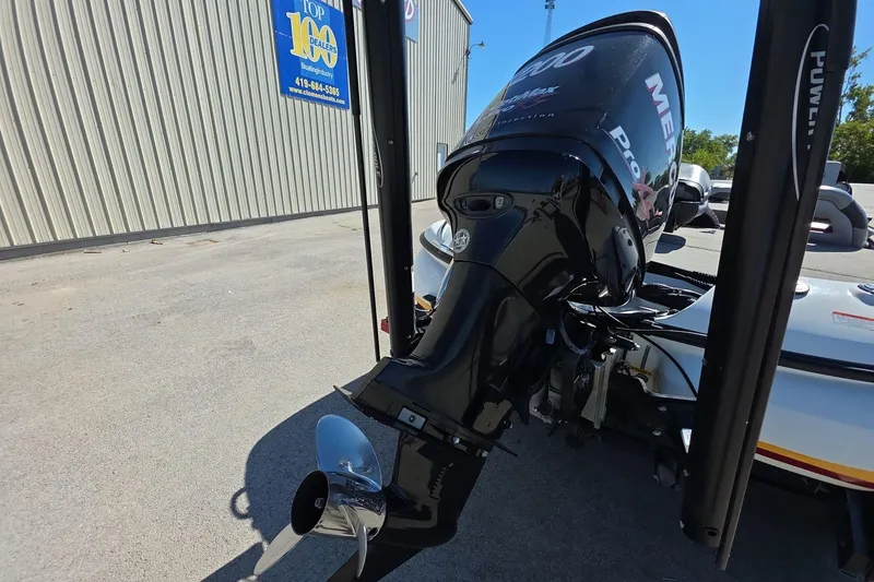 Slide: The Image of 2011 Nitro Z-8 boat with Mercury Pro XS outboard motor, parked near a dealership. - 4
