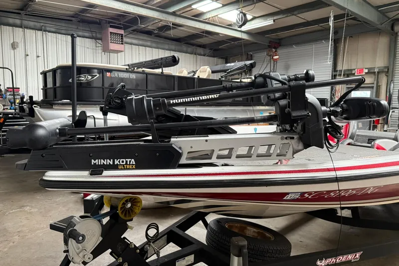 Slide: The Image of 2017 Phoenix 920 ProXP boat with Minn Kota Ultrex and Humminbird equipment in a garage. - 2
