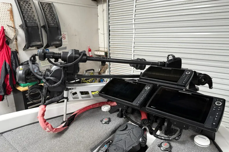 Slide: The Image of 2017 Phoenix 920 ProXP boat with advanced navigation and sonar equipment in a garage setting. - 3