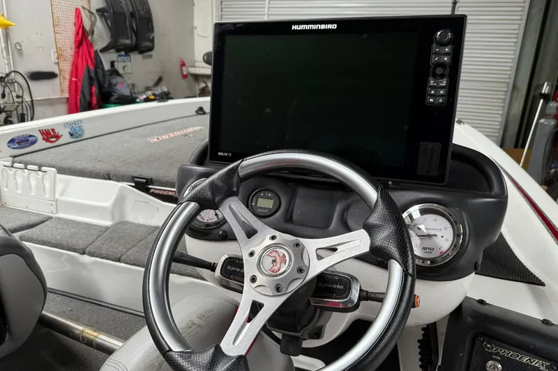 Slide: The Image of 2017 Phoenix 920 ProXP boat dashboard with steering wheel and Humminbird display. - 4