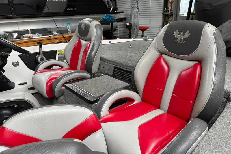 Slide: The Image of 2017 Phoenix 920 ProXP boat interior with red and gray seats, steering wheel visible. - 7