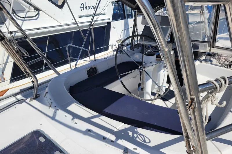 Slide: The Image of 2001 Hunter Passage 420 sailboat cockpit with steering wheel and seating area. - 10