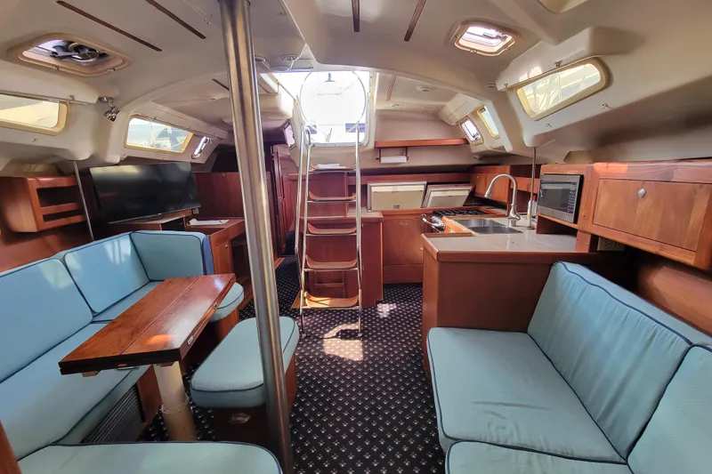 Slide: The Image of Interior of 2001 Hunter Passage 420 yacht with cozy seating and modern kitchen. - 15
